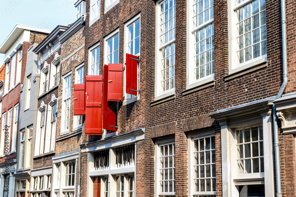 Naklejka premium Street with old Dutch houses in Dordrecht, Zuid-Holland, The Netherlands, Europe