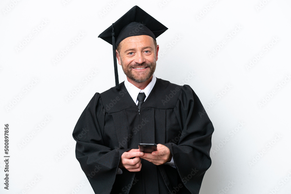 Middle age university graduate man isolated on white background sending a message with the mobile Middle age university graduate man isolated on white background sending a message with the mobile