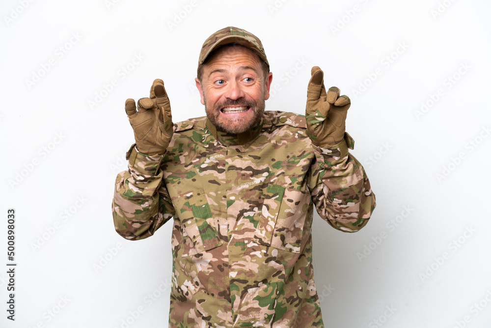 Military man isolated on white background with fingers crossing Military man isolated on white background with fingers crossing
