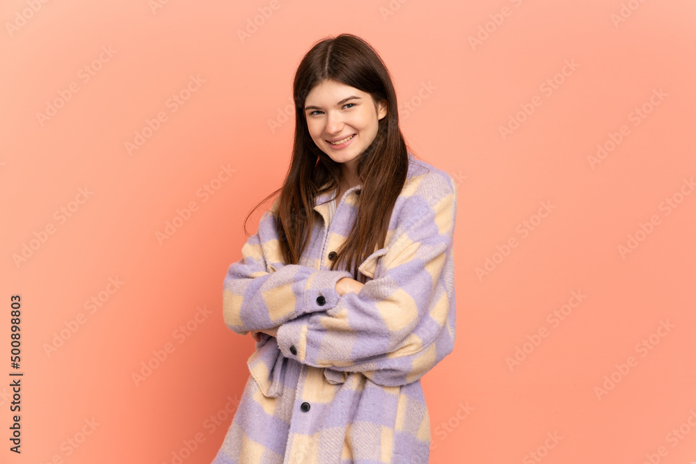 Young Ukrainian girl isolated on pink background with arms crossed and looking forward Young Ukrainian girl isolated on pink background with arms crossed and looking forward