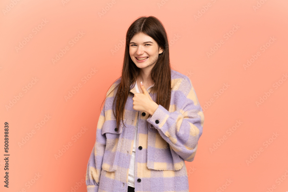 Young Ukrainian girl isolated on pink background giving a thumbs up gesture Young Ukrainian girl isolated on pink background giving a thumbs up gesture