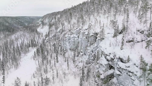 View At The Side Of Korouoma Canyon With Pine Trees And Frozen Waterfalls In Lapland, Finland - Aerial photo