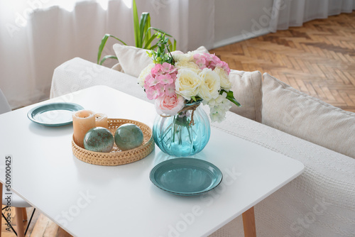 Flowers in a blue vase on a white table