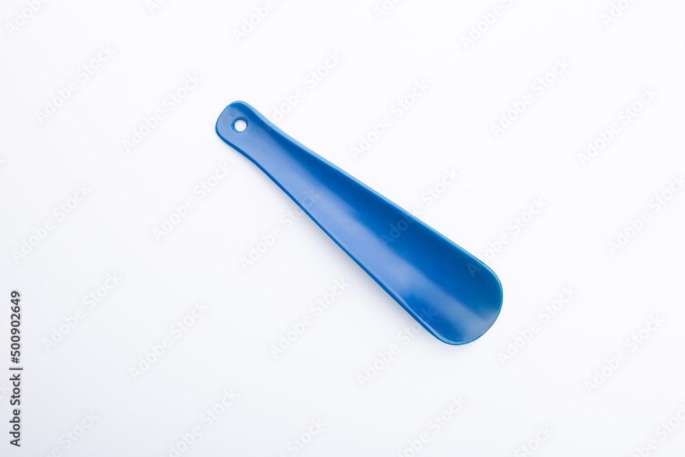 blue plastic shoehorn on a white background blue plastic shoehorn on a white background