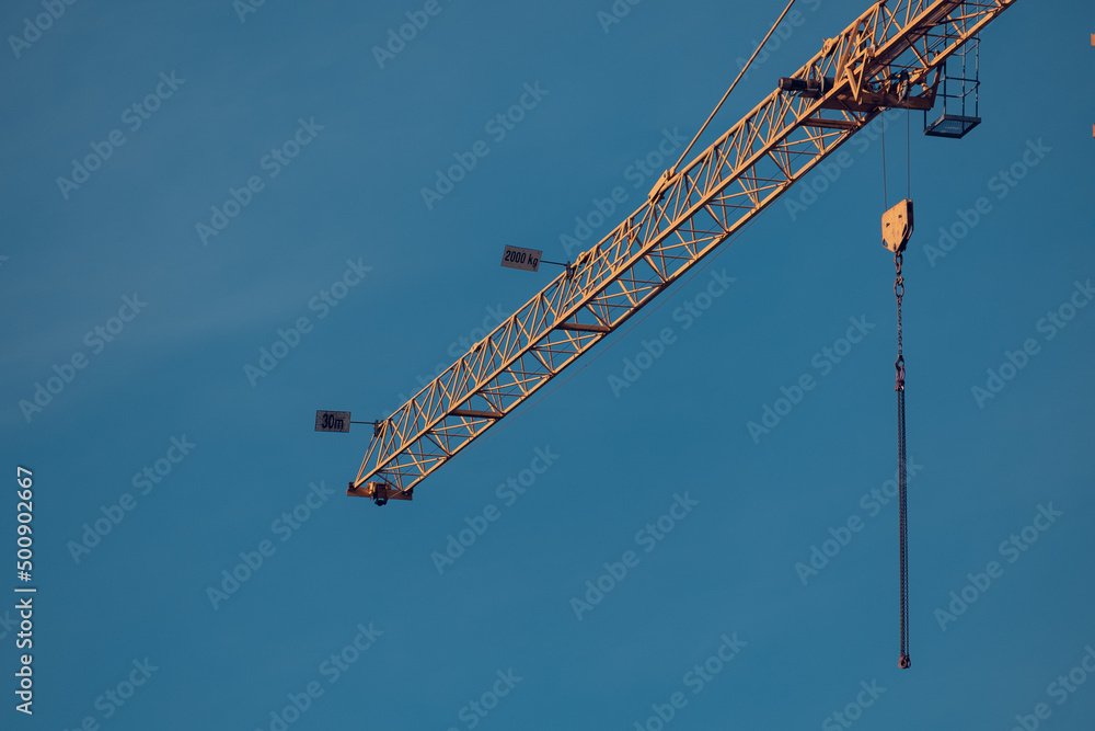 Tower crane over a house under construction Tower crane over a house under construction