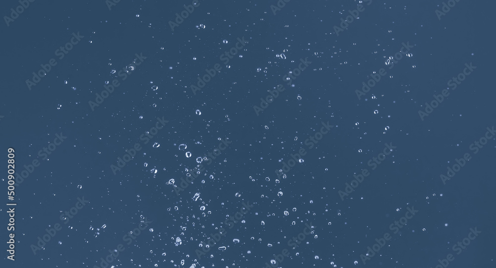Water splash on a blue background. Reflection on the surface of the water. Water splash on a blue background. Reflection on the surface of the water.