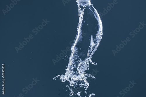Water splash on a blue background. Reflection on the surface of the water.