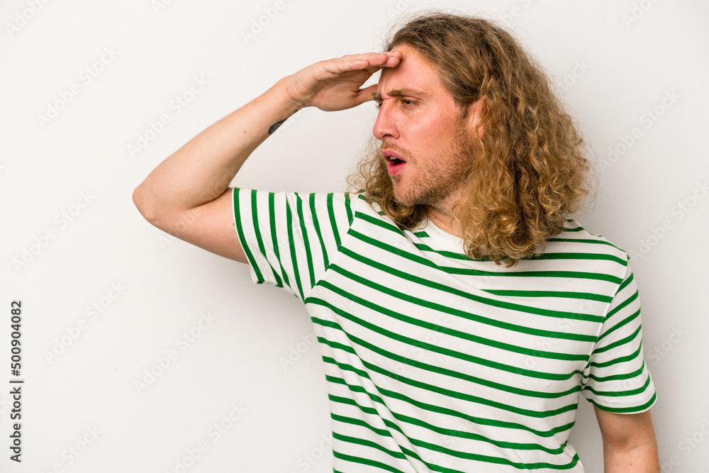 Young caucasian man isolated on white background looking far away keeping hand on forehead. Young caucasian man isolated on white background looking far away keeping hand on forehead.