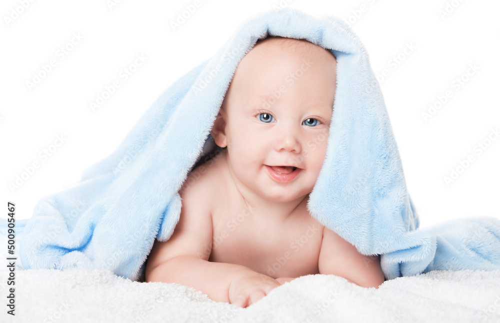 Happy Baby Boy in Blue Towel after Bath. Smiling Cute Child after washing in Shower lying down on Stomach over White Blanket. Newborn Skin Care and Bathing over isolated Studio Background Happy Baby Boy in Blue Towel after Bath. Smiling Cute Child after washing in Shower lying down on Stomach over White Blanket. Newborn Skin Care and Bathing over isolated Studio Background