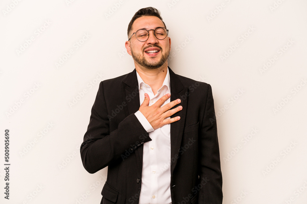 Business hispanic man isolated on white background laughs out loudly keeping hand on chest. Business hispanic man isolated on white background laughs out loudly keeping hand on chest.