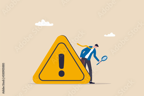 Incident management, root cause analysis or solving problem, identify risk or critical failure concept, businessman with magnifier monitor and investigate incident with exclamation attention sign. photo