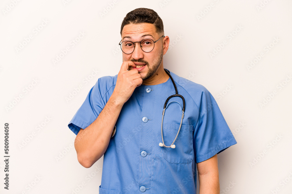 Hispanic nurse man isolated on white background biting fingernails, nervous and very anxious. Hispanic nurse man isolated on white background biting fingernails, nervous and very anxious.