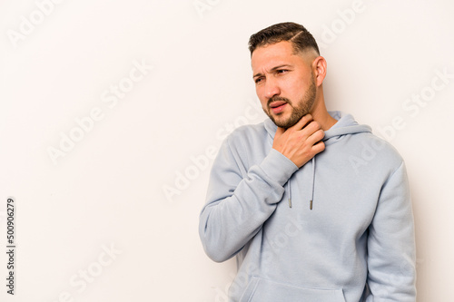 Young hispanic man isolated on white background touching back of head, thinking and making a choice.