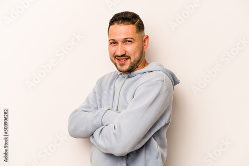 Young hispanic man isolated on white background happy, smiling and cheerful.