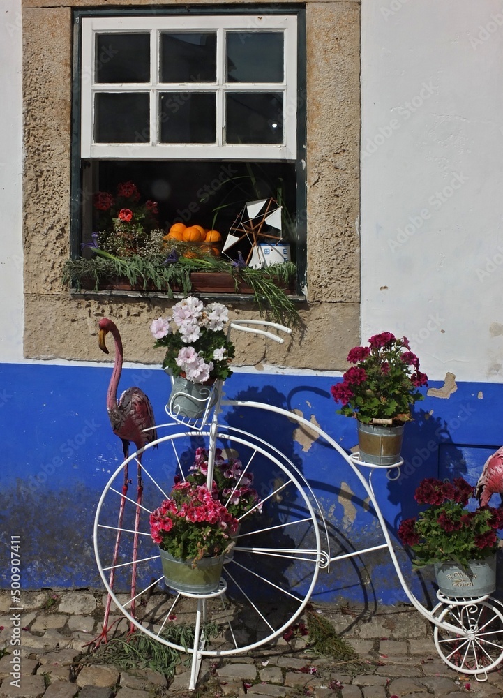 Colorful decoration with metal decorative bike, flamingo, and old window