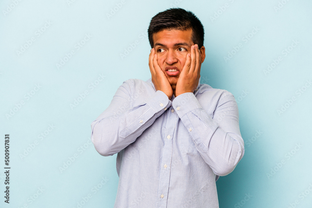Young hispanic man isolated on blue background scared and afraid. Young hispanic man isolated on blue background scared and afraid.