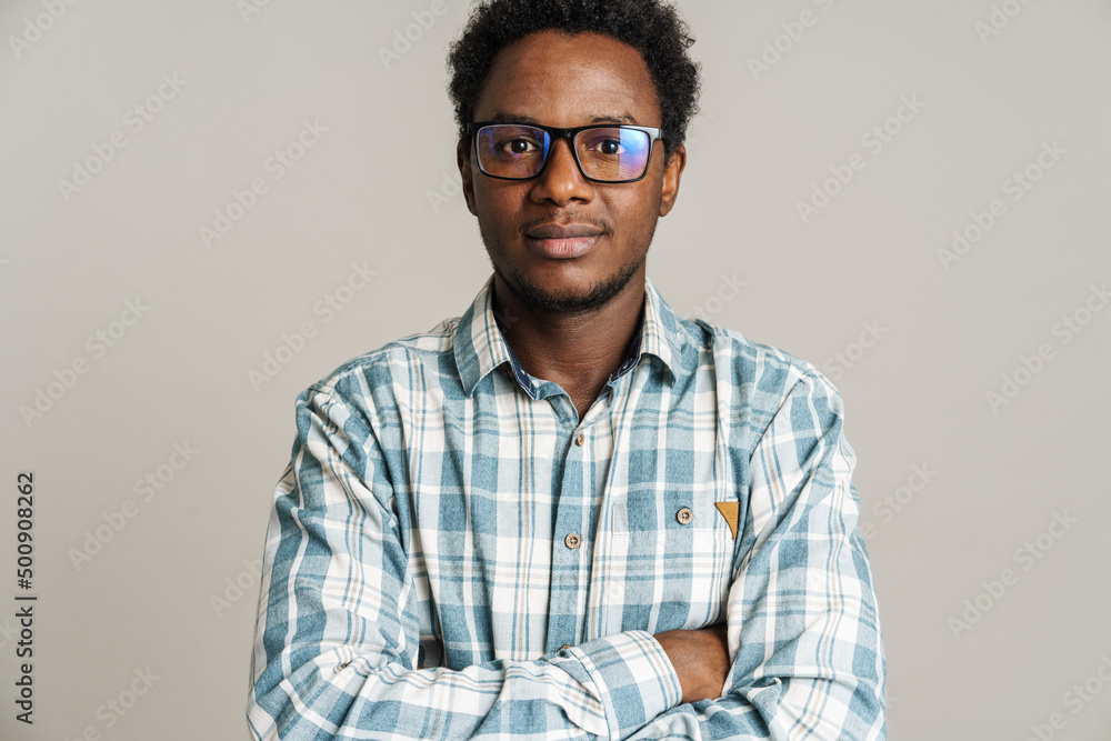 Young black man wearing eyeglasses posing and looking at camera Young black man wearing eyeglasses posing and looking at camera