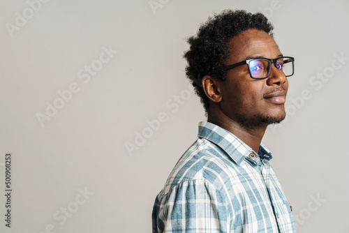 Obraz na plátně Young black man wearing eyeglasses posing and looking aside
