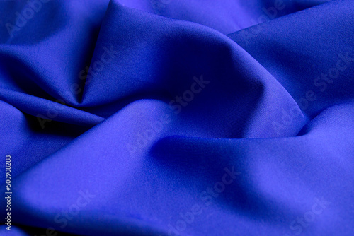 Folds of blue fabric for the background. © Maksim