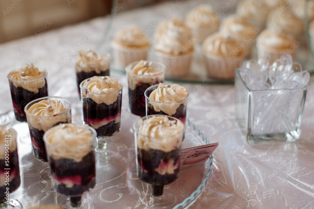 Various desserts and cake on the buffet table at the wedding