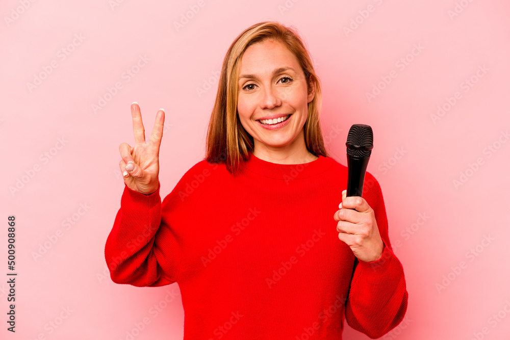 Young caucasian singer woman isolated on pink background showing number two with fingers. Young caucasian singer woman isolated on pink background showing number two with fingers.