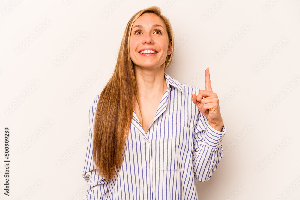 Young caucasian woman isolated on white background indicates with both fore fingers up showing a blank space. Young caucasian woman isolated on white background indicates with both fore fingers up showing a blank space.