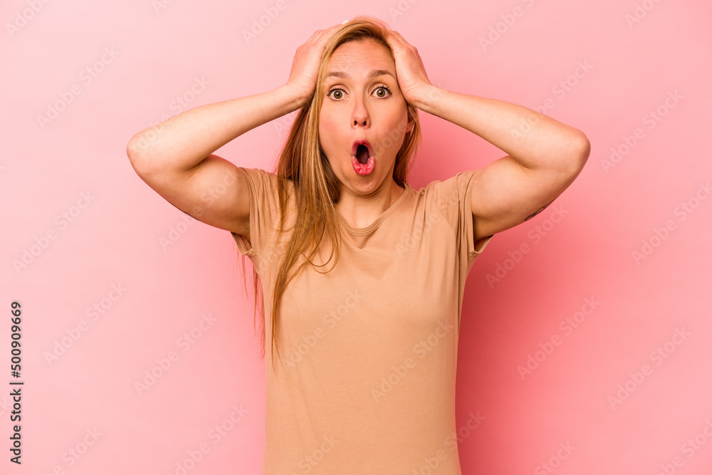 Young caucasian woman isolated on pink background surprised and shocked. Young caucasian woman isolated on pink background surprised and shocked.
