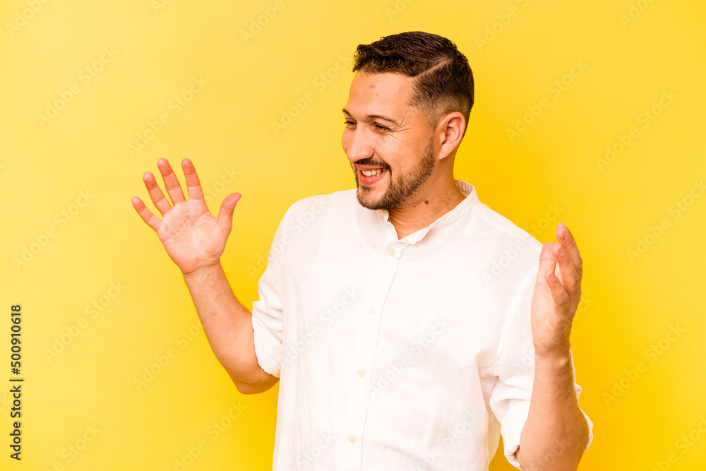 Young hispanic man isolated on yellow background joyful laughing a lot. Happiness concept. Young hispanic man isolated on yellow background joyful laughing a lot. Happiness concept.