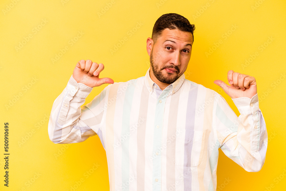 Young hispanic man isolated on yellow background feels proud and self confident, example to follow. Young hispanic man isolated on yellow background feels proud and self confident, example to follow.