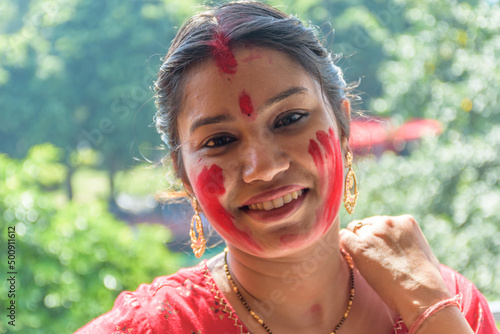 Happy young Bengali woman celebrates Sindur Khela tradition in Durga puja festival. Durga puja festival is one of the biggest festival in India photo