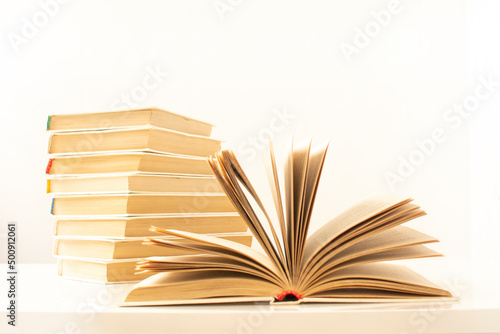 a stack of books and an open book. Books background for science and education. Reading and writing concept