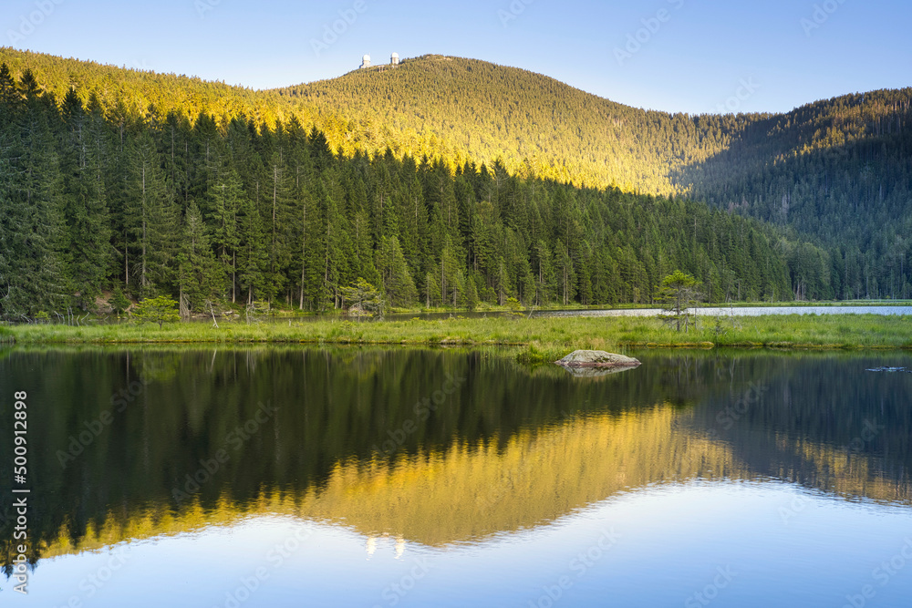Beautiful Small Arber lake in the Bavarian Forest at sunset. View to mount Großer Arber.