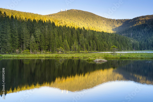 Beautiful Small Arber lake in the Bavarian Forest at sunset. View to mount Gro  er Arber.