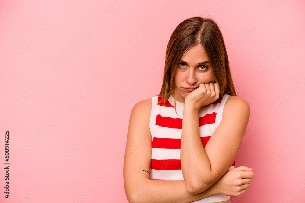 Young caucasian woman isolated on pink background who feels sad and pensive, looking at copy space. Young caucasian woman isolated on pink background who feels sad and pensive, looking at copy space.