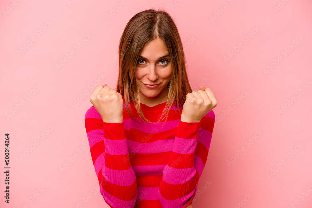 Young caucasian woman isolated on pink background upset screaming with tense hands. Young caucasian woman isolated on pink background upset screaming with tense hands.