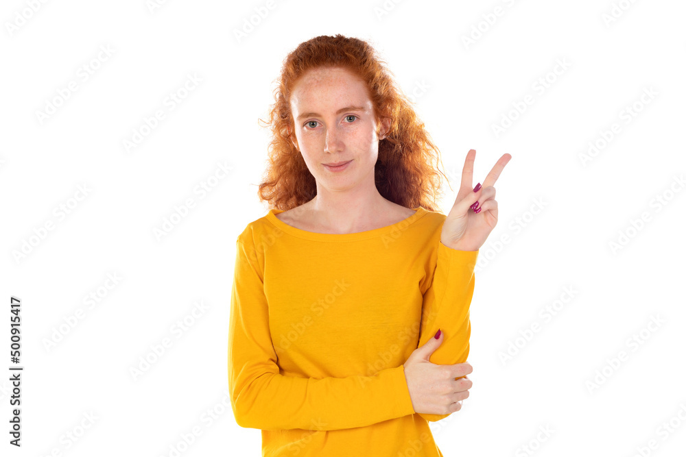 Redheaded pretty woman smiling and looking happy, friendly and satisfied, gesturing victory or peace Redheaded pretty woman smiling and looking happy, friendly and satisfied, gesturing victory or peace