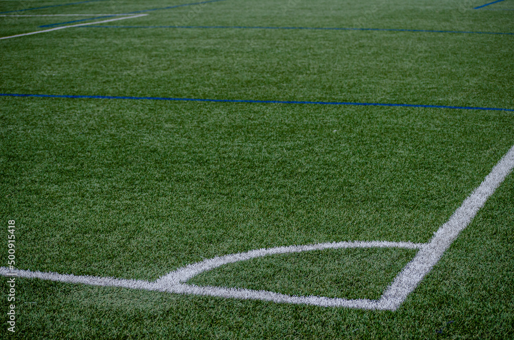 Corner line of a blue artificial turf football field