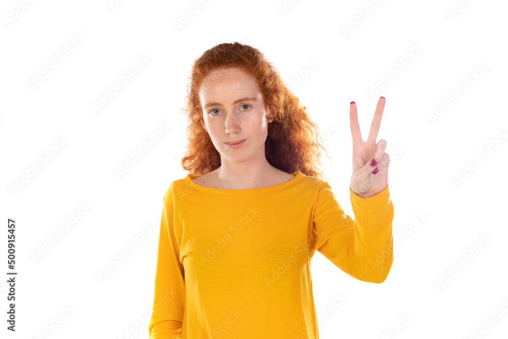 Redheaded pretty woman smiling and looking happy, friendly and satisfied, gesturing victory or peace Redheaded pretty woman smiling and looking happy, friendly and satisfied, gesturing victory or peace