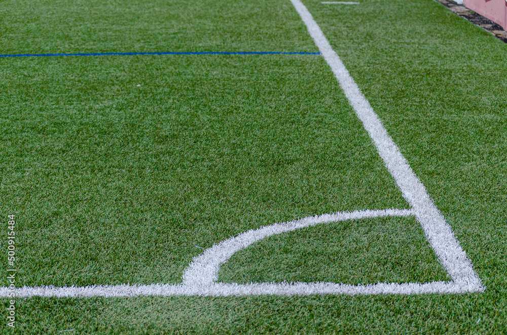 Corner line of a blue artificial turf soccer field