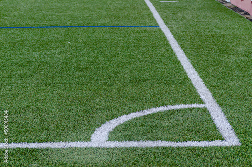 Corner line of a blue artificial turf soccer field