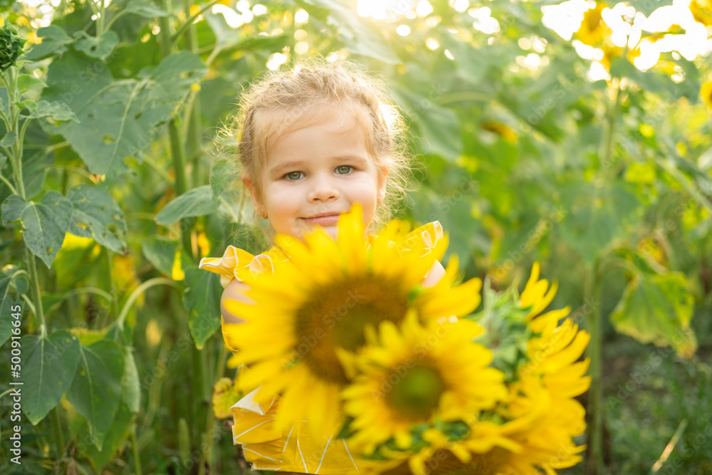 happy little kid girl playing in blooming sunflower field on sunny summer day happy little kid girl playing in blooming sunflower field on sunny summer day