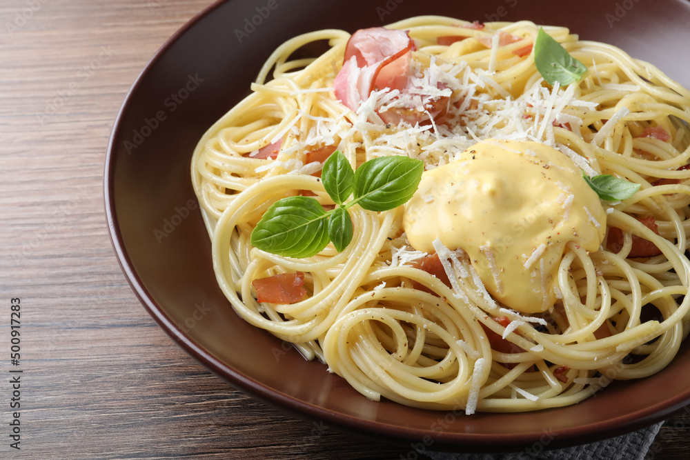 Delicious spaghetti with cheese sauce and meat on wooden table, closeup