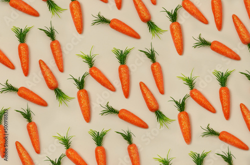 Paterrn made of orange carrots. Minimal flat lay background. photo