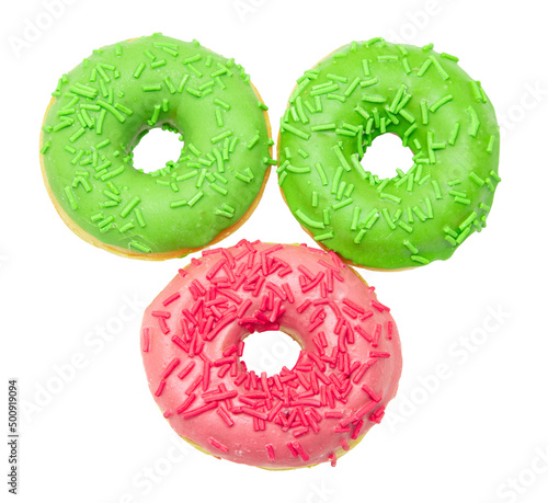 fried donuts with pink and green icing on a white plate