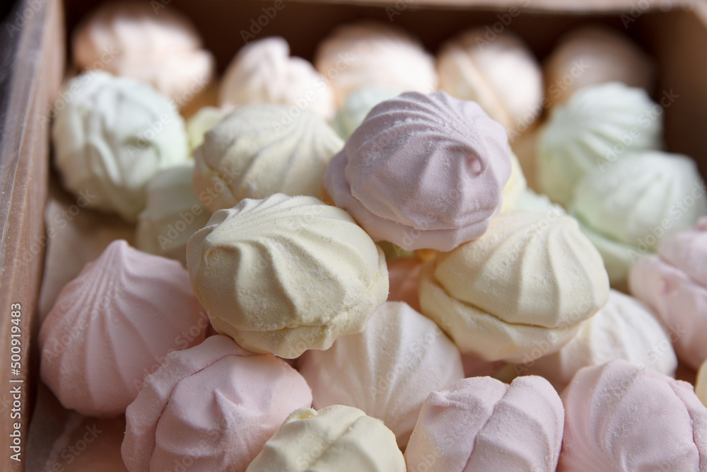 Fresh multicolored marshmallow lies in cardboard packaging prepared for sale in stores Fresh multicolored marshmallow lies in cardboard packaging prepared for sale in stores