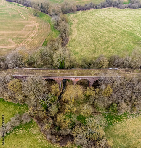 An aerial view looking down onto the abandoned Ingarsby Viaduct in Leicestershire, UK in early spring photo