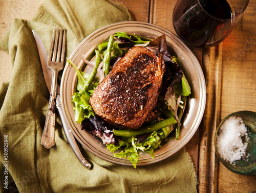 Sliced Grass Fed Sirloin Steak on a Bed of greens photo