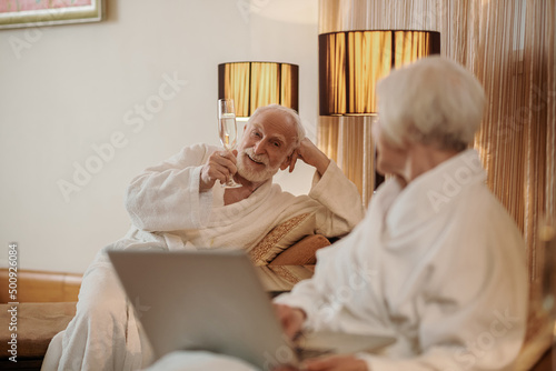 A senior couple searching for something on internet and looking interested