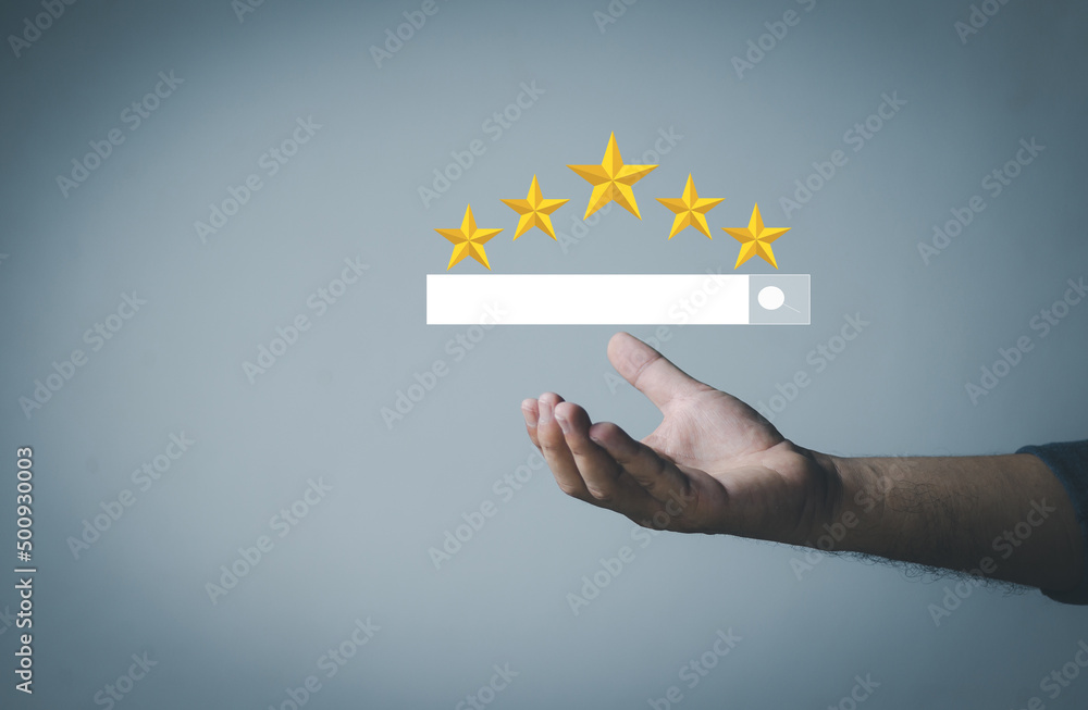 Customer Satisfaction Survey Concept, A man's hand using a smartphone gives a 5 star rating to show the highest level of satisfaction with excellent service.. Customer Satisfaction Survey Concept, A man's hand using a smartphone gives a 5 star rating to show the highest level of satisfaction with excellent service..