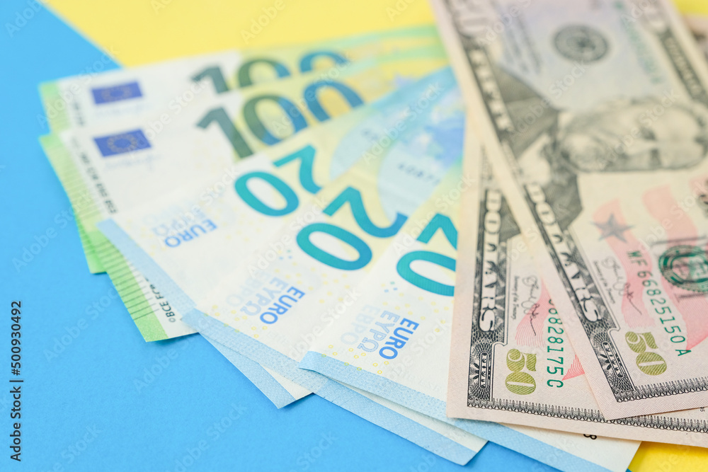 Euro money and american dollars on a colour paper background Euro money and american dollars on a colour paper background